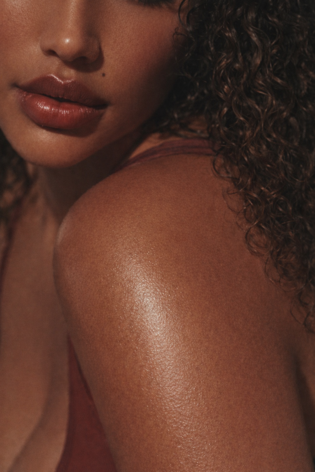 woman with glowing skin wearing body oil