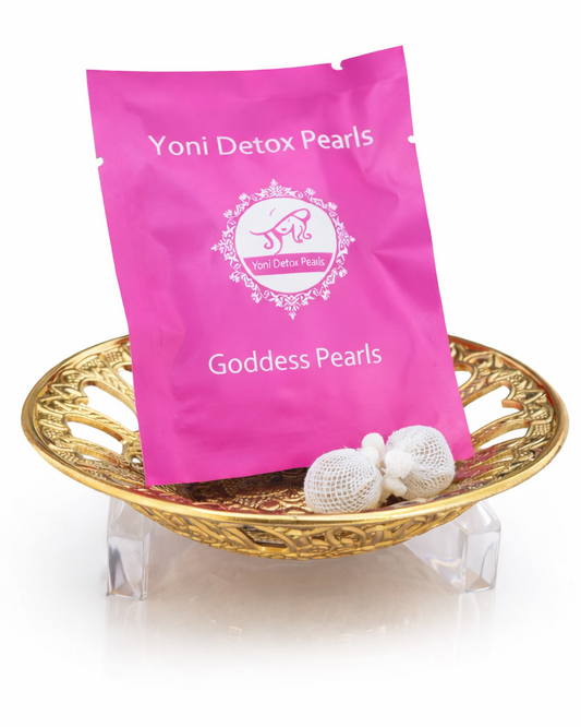 Pink package of Yoni Detox Pearls with pearls on a gold tray on a white background